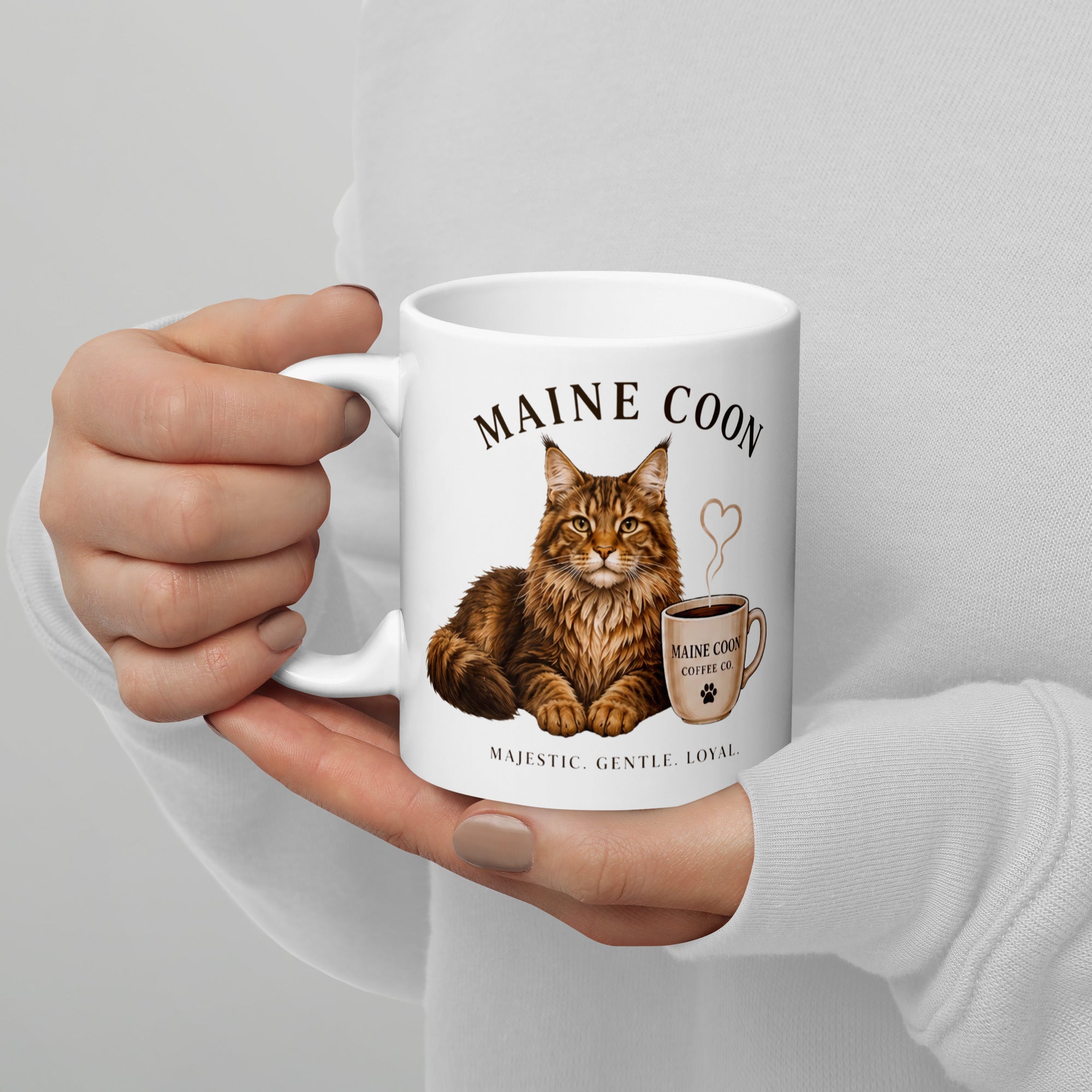 Woman in white jumper holding Maine Coon coffee mug from the Pawprint Society