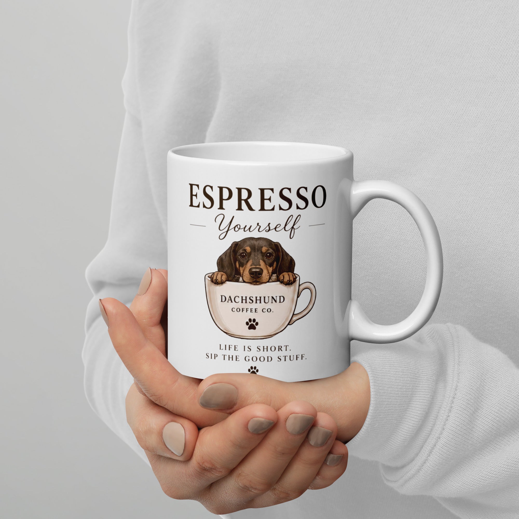 Woman cupping dachshund Espresso Yourself coffee mug in her hands