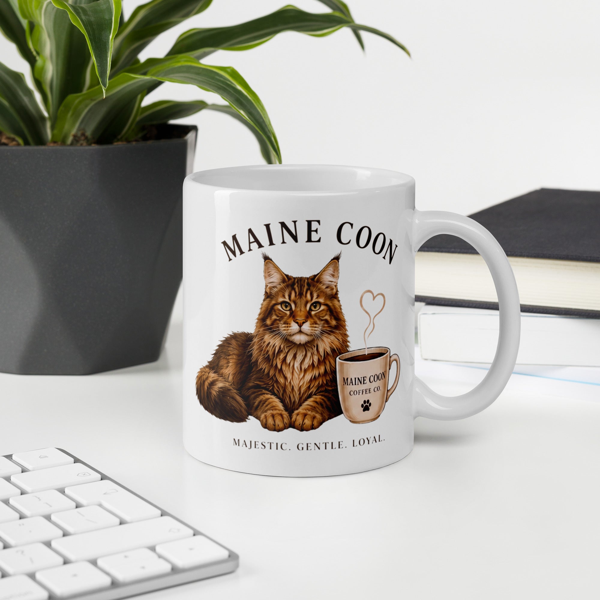 Coffee mug on desk with picture of Maine Coon